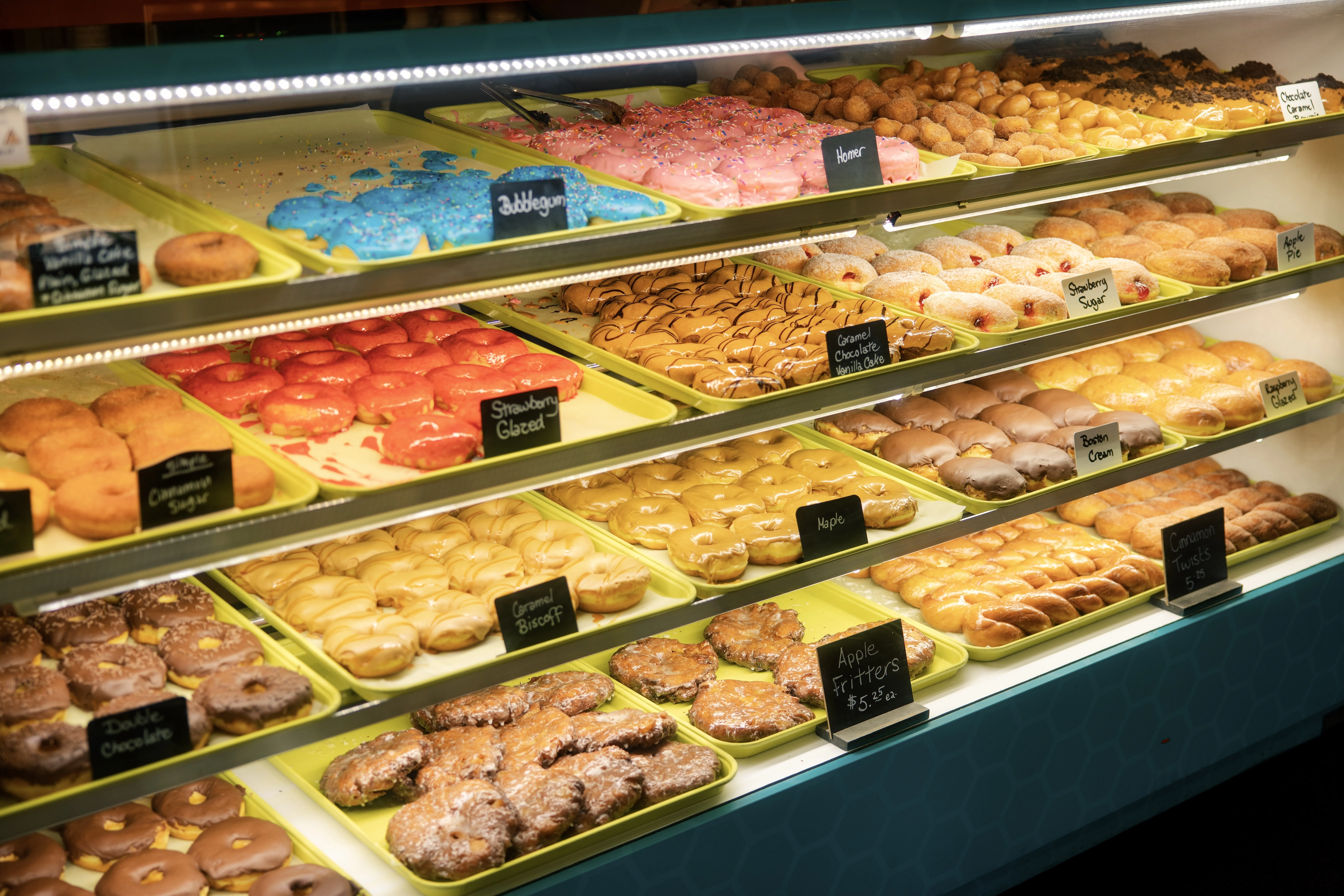 A casing of donuts, some are almost sold out but there are plenty left.