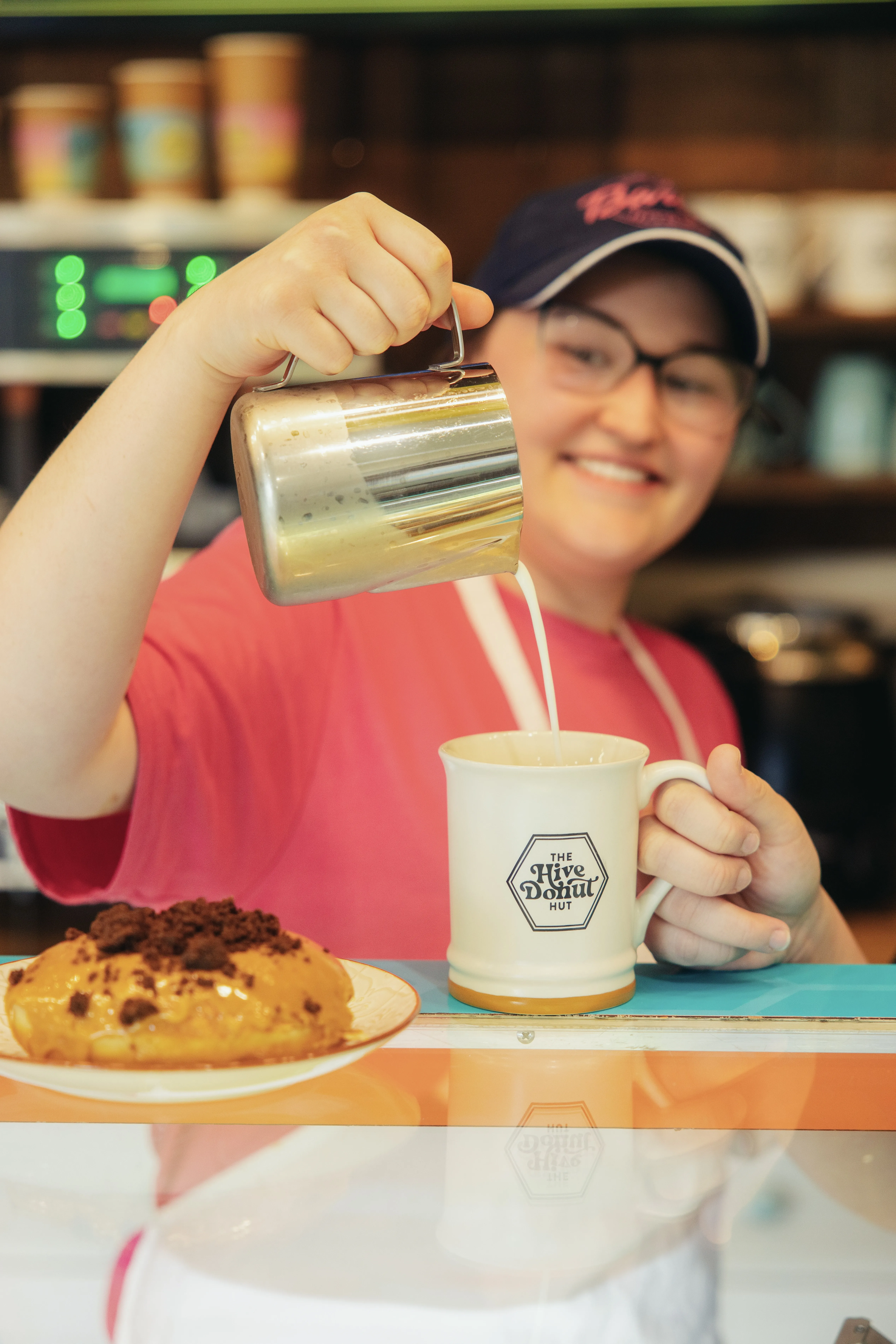 A woman pouring a drink into a cup.
