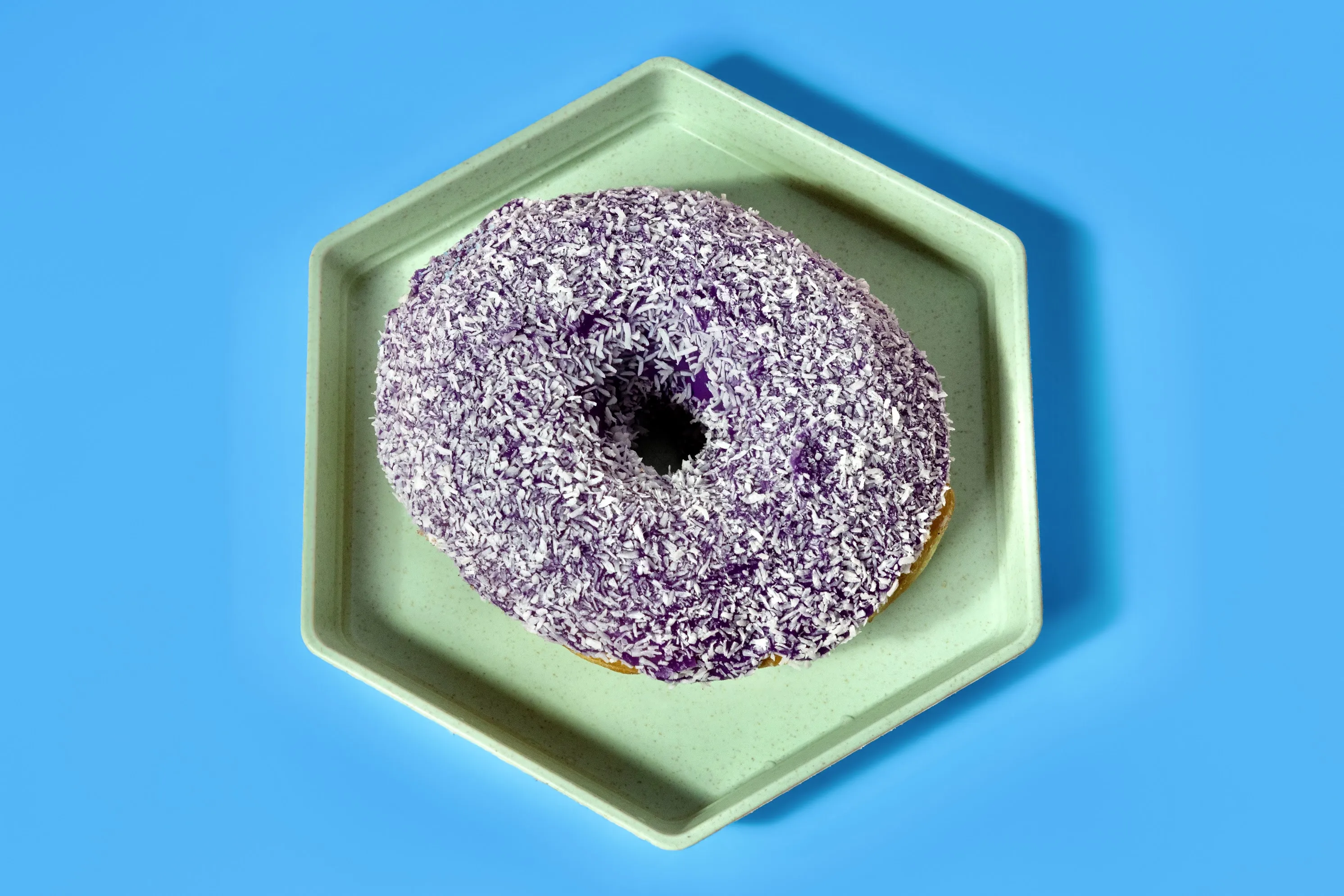 A purple-glazed donut made at The Hive Donut Hut.